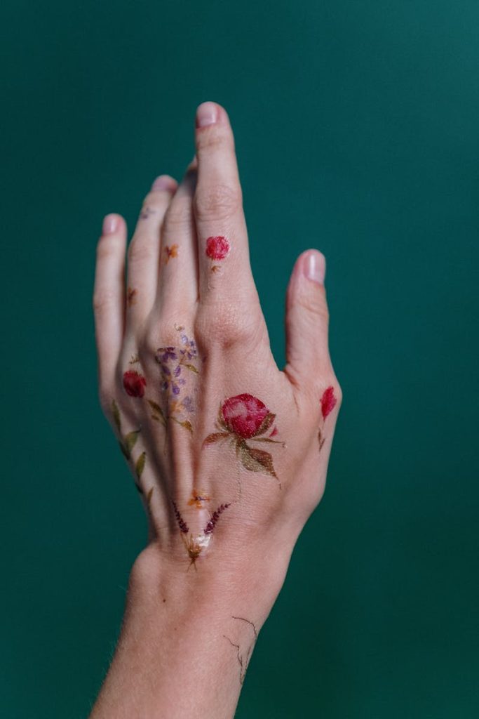 Photo of Flower Tattoos on Person's Left Hand